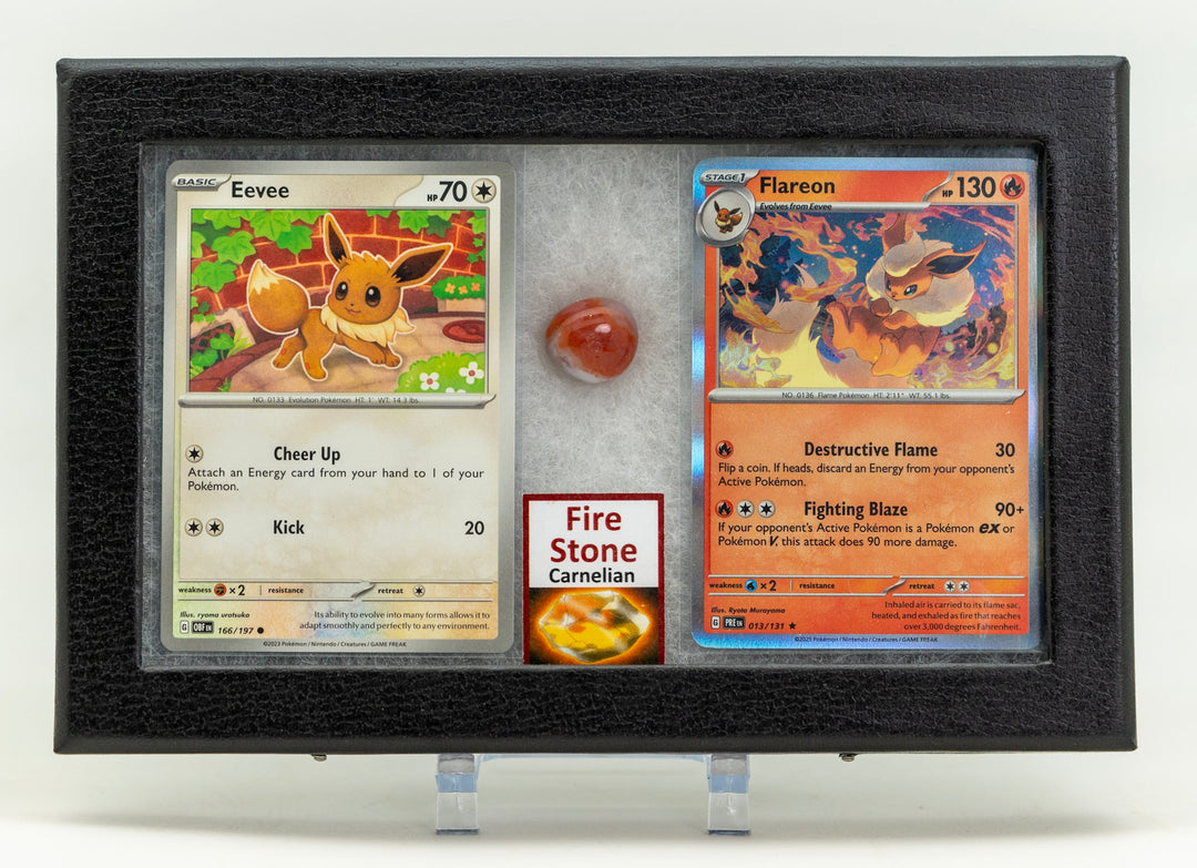 Two trading cards displayed in a black frame with a red gemstone.
