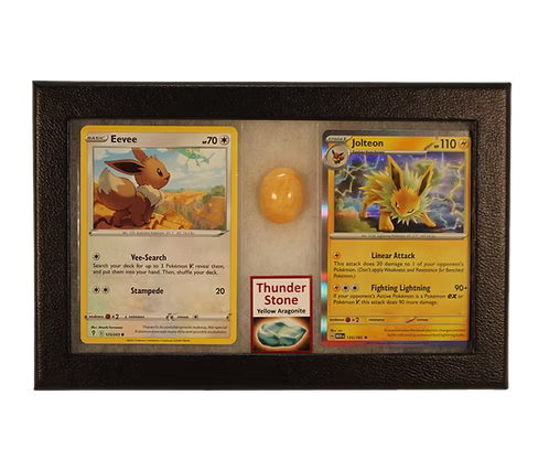 Two trading cards featuring Eevee and Jolteon in a display case with a Thunder Stone card.