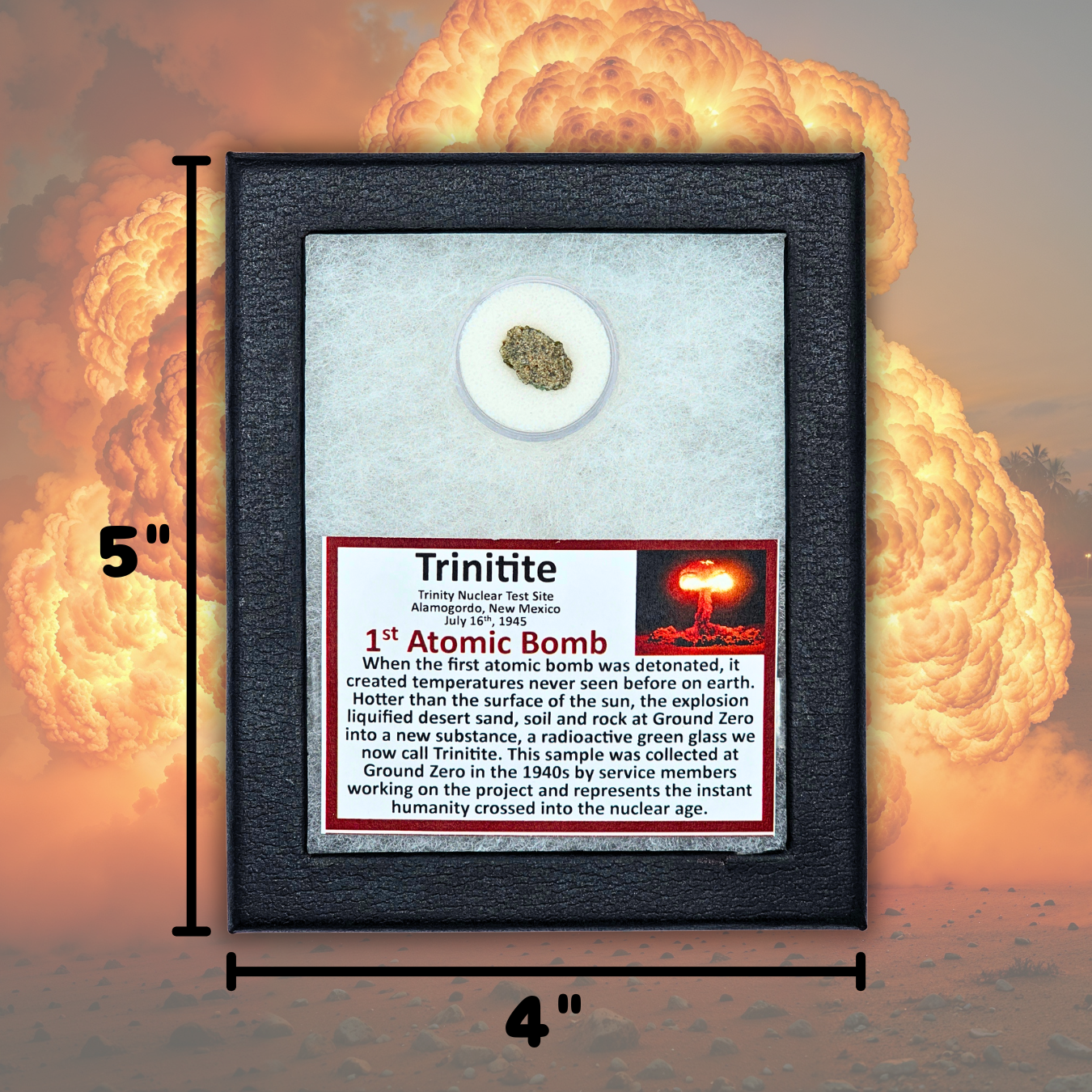 A framed 1st Atomic Bomb sample display labeled 'Trinitite' with a small green  glass vial in the center, shown against a large nuclear explosion backdrop. The frame is marked 5 inches tall by 4 inches wide, and the plaque includes a red-and-black nuclear illustration and historical text.